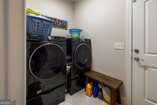 clothes washing area with tile patterned floors and washing machine and dryer