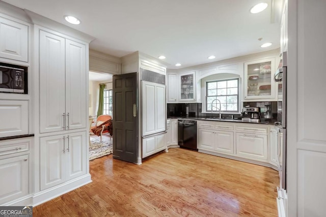 kitchen featuring built in microwave, white cabinets, sink, and dishwasher