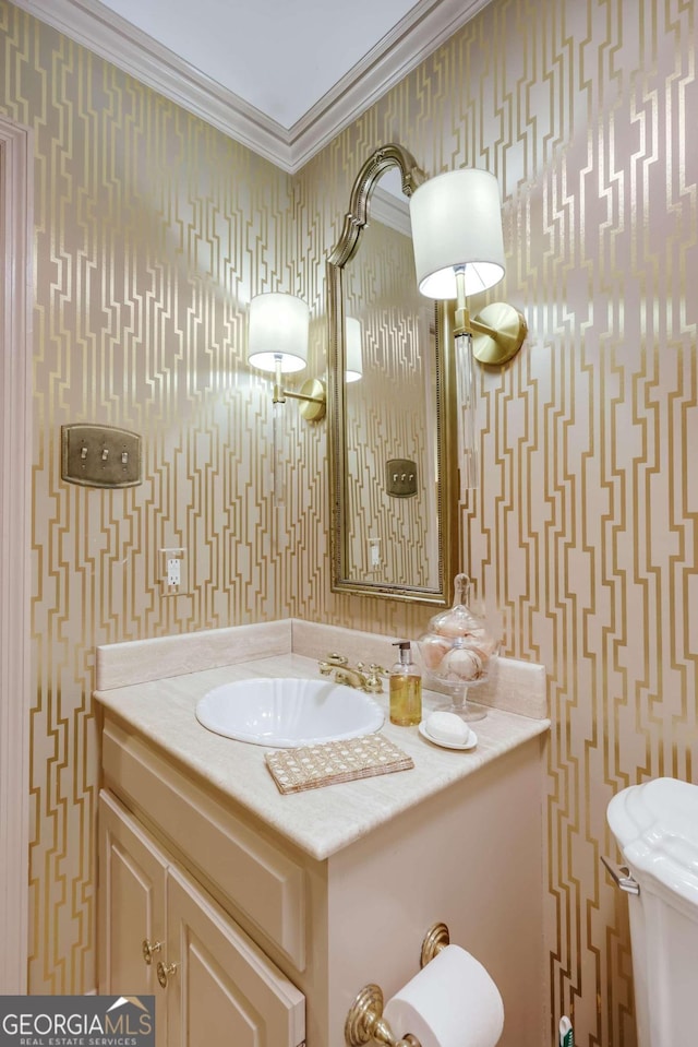 bathroom with vanity, ornamental molding, and toilet