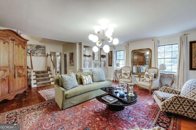 living room with dark hardwood / wood-style flooring and a chandelier