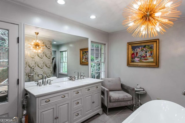 bathroom featuring a bathtub, vanity, crown molding, tile patterned floors, and an inviting chandelier