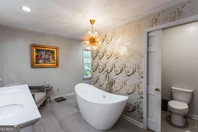 bathroom featuring tile patterned floors, toilet, an inviting chandelier, vanity, and a bathtub