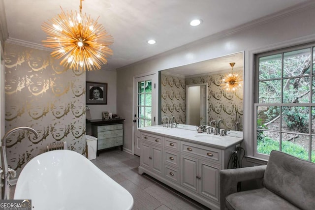 bathroom with crown molding, plenty of natural light, a bath, and a chandelier