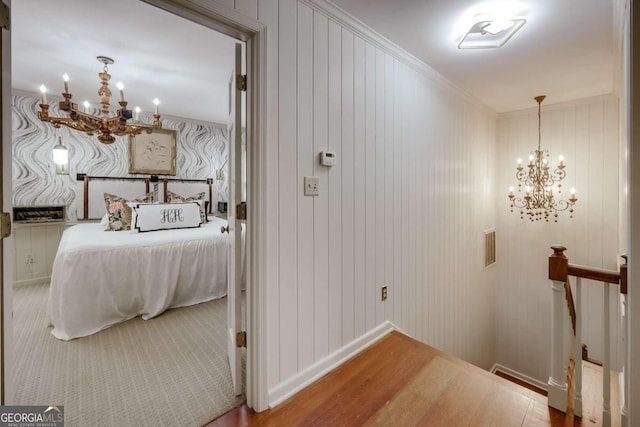 interior space featuring an inviting chandelier, hardwood / wood-style flooring, and crown molding