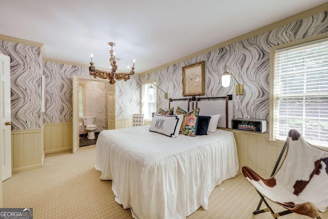 carpeted bedroom featuring an inviting chandelier and crown molding