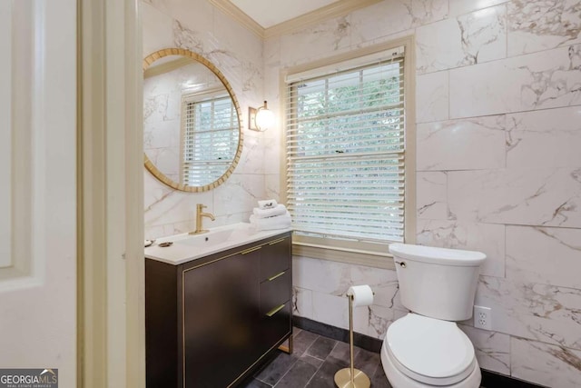 bathroom featuring tile walls, vanity, ornamental molding, and toilet