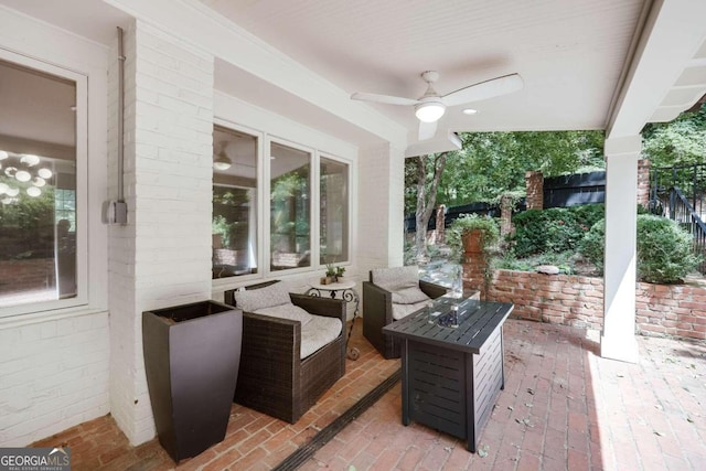 view of patio with an outdoor living space with a fire pit and ceiling fan