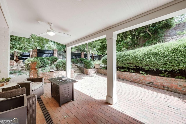 wooden terrace featuring ceiling fan and a patio area