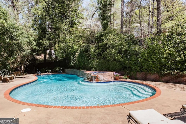 view of swimming pool featuring a patio