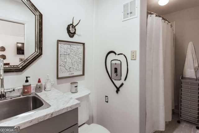 bathroom featuring vanity and toilet