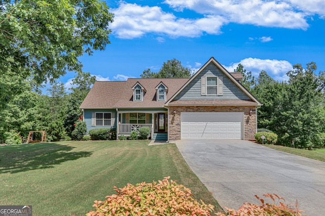 view of front of house featuring covered porch, a garage, and a front yard