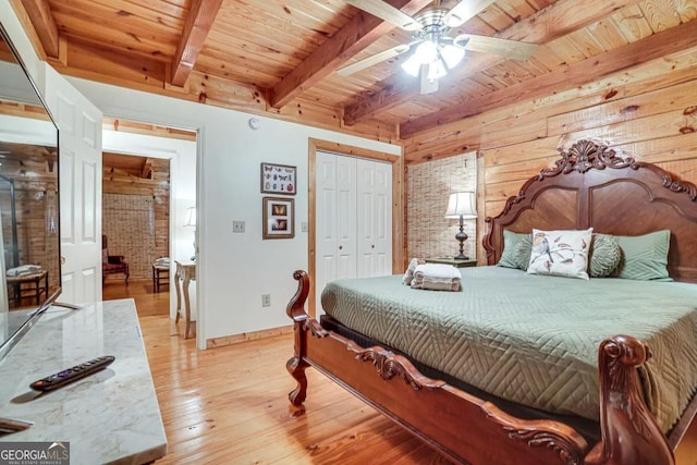 bedroom featuring ceiling fan, beam ceiling, wooden ceiling, and hardwood / wood-style floors