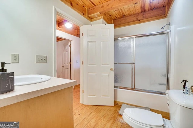 full bathroom featuring beamed ceiling, wood-type flooring, vanity, wood ceiling, and toilet