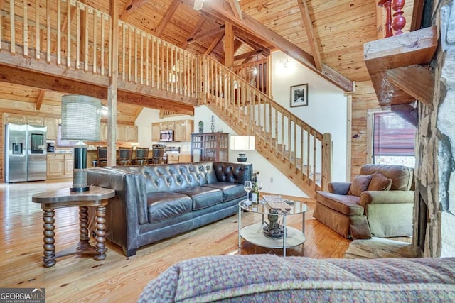 living room with beamed ceiling, high vaulted ceiling, wood ceiling, and light hardwood / wood-style flooring