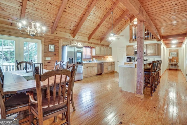 dining space featuring light hardwood / wood-style flooring, wood ceiling, wooden walls, ceiling fan with notable chandelier, and beamed ceiling