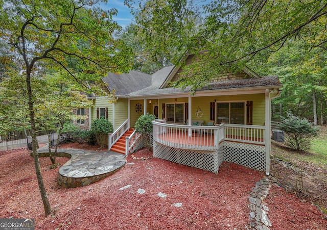 view of front of property with central AC unit and a wooden deck