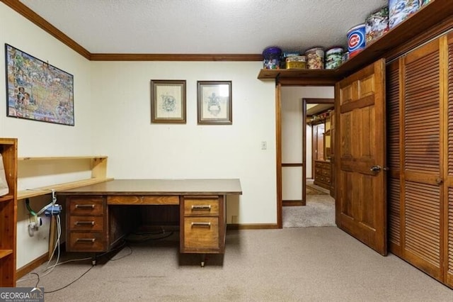 home office featuring built in desk, light colored carpet, and a textured ceiling