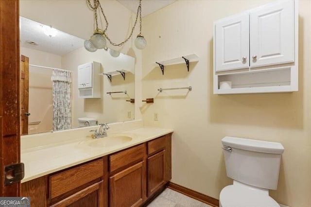 bathroom with tile patterned flooring, toilet, and vanity