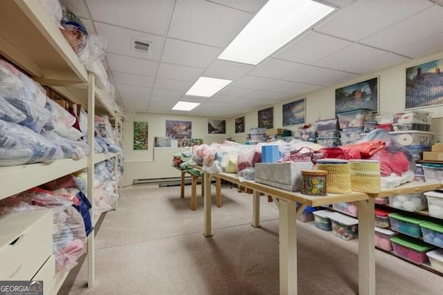 playroom featuring light carpet and a drop ceiling