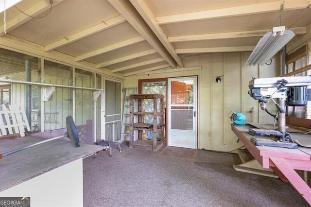 interior space featuring vaulted ceiling with beams and carpet flooring