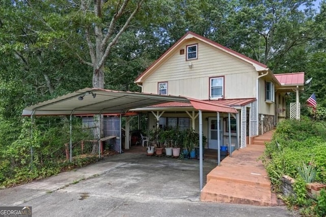 back of house with a carport