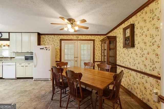 dining space with light tile patterned flooring, a healthy amount of sunlight, a textured ceiling, and ceiling fan