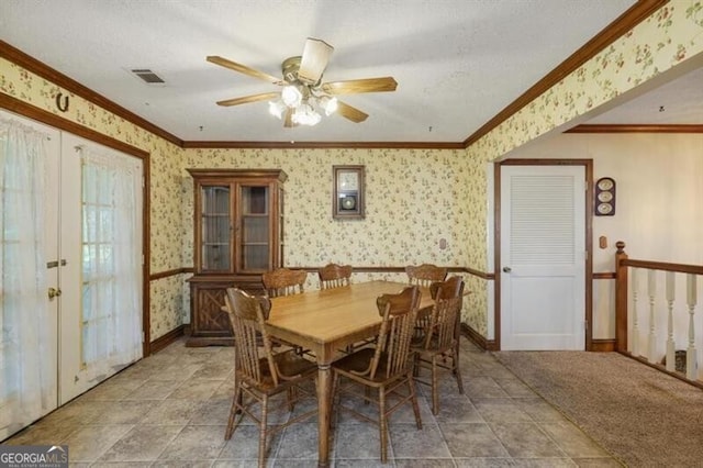 tiled dining area featuring ornamental molding and ceiling fan