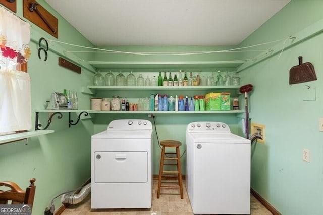 laundry room with washing machine and dryer and light tile patterned floors