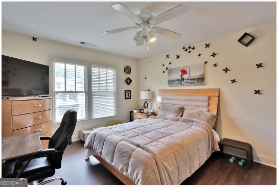 bedroom featuring ceiling fan and dark hardwood / wood-style flooring