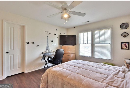 bedroom with dark hardwood / wood-style floors and ceiling fan