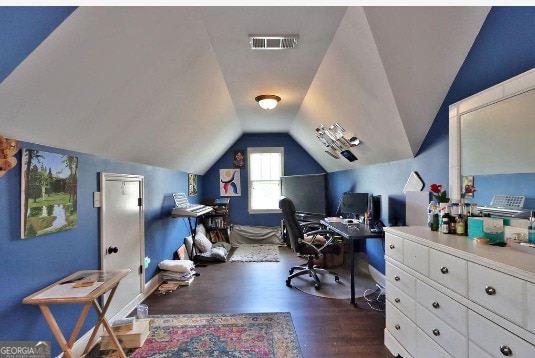 office space featuring vaulted ceiling and dark wood-type flooring