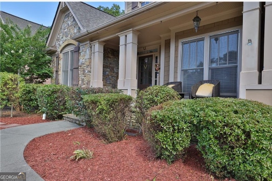 view of exterior entry with a porch