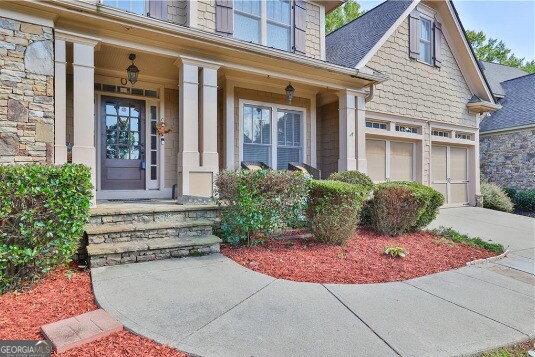 doorway to property featuring covered porch and a garage