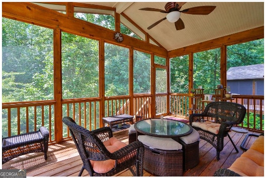 sunroom / solarium featuring ceiling fan and vaulted ceiling