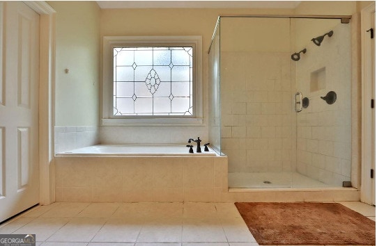 bathroom featuring separate shower and tub and tile patterned flooring