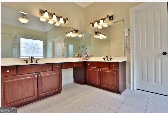 bathroom with dual vanity and tile patterned floors