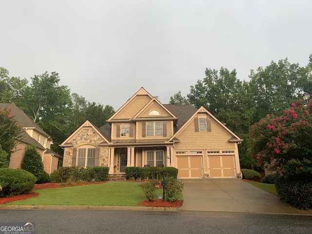 craftsman-style home with a garage and a front lawn