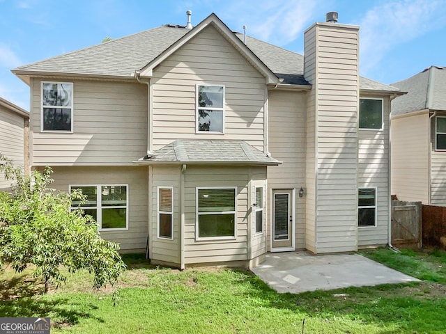 rear view of property featuring a yard and a patio