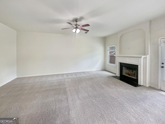 unfurnished living room featuring light colored carpet and ceiling fan