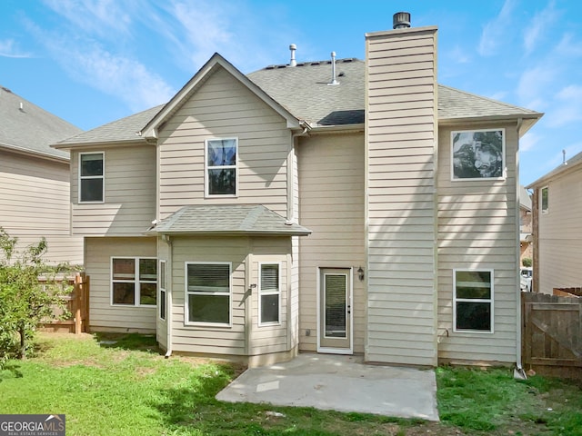 back of property with a patio and a lawn