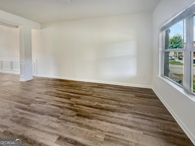 unfurnished room featuring dark hardwood / wood-style flooring