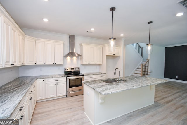 kitchen with decorative light fixtures, an island with sink, sink, stainless steel range with electric cooktop, and wall chimney exhaust hood