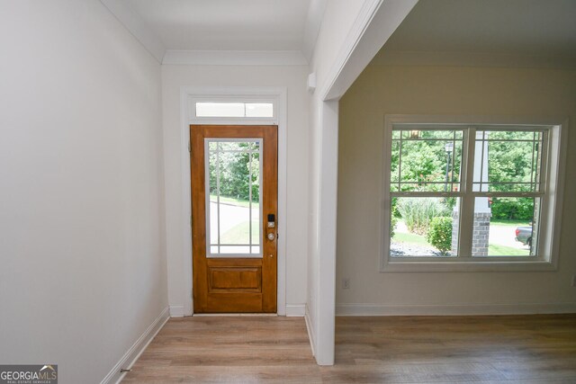 entryway featuring crown molding and light hardwood / wood-style flooring