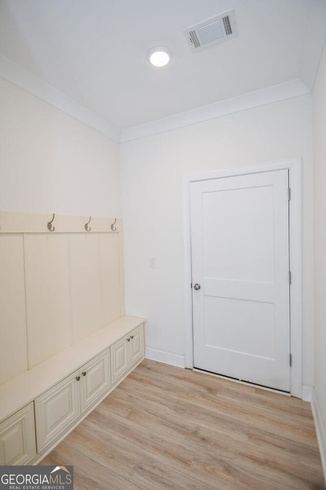 mudroom featuring crown molding and light hardwood / wood-style flooring