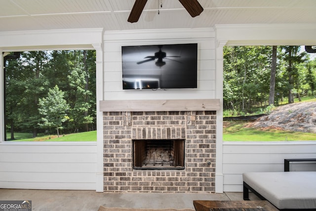 view of patio with an outdoor brick fireplace and ceiling fan