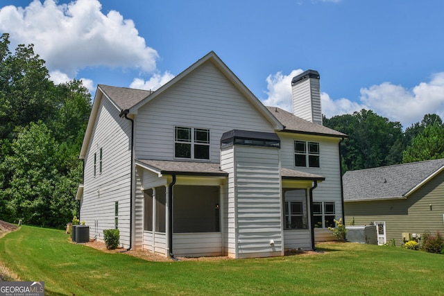 back of house with cooling unit, a lawn, and a sunroom