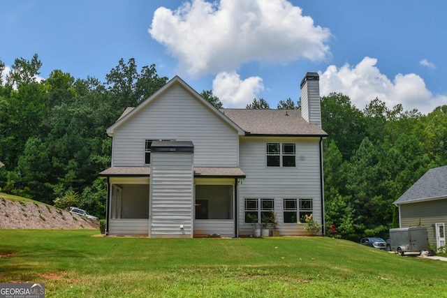 back of house featuring a yard