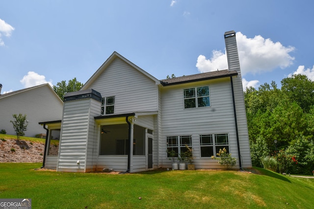 rear view of house featuring a yard