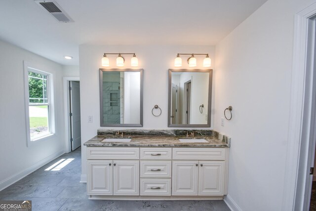 bathroom with dual vanity and tile patterned floors