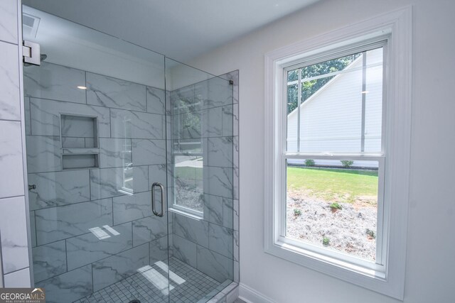 bathroom featuring a shower with shower door